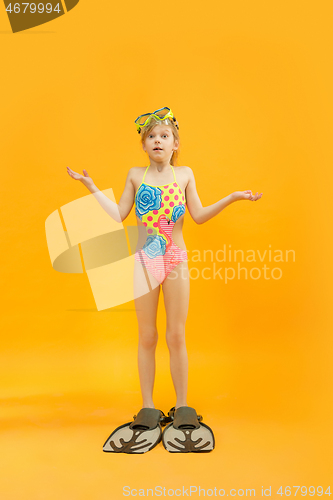 Image of Girl wearing swimwear standing with snorkelers and flippers
