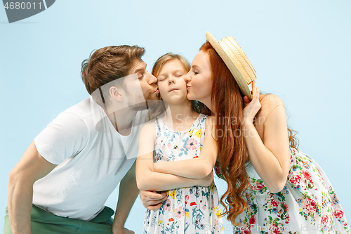 Image of Happy parent with daughter at studio isolated on blue background