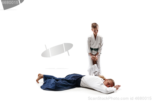 Image of Man and teen boy fighting at aikido training in martial arts school