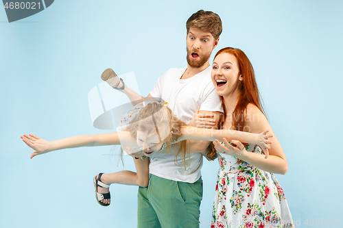 Image of Happy parent with daughter at studio isolated on blue background