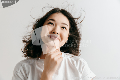 Image of Young serious thoughtful business woman. Doubt concept.