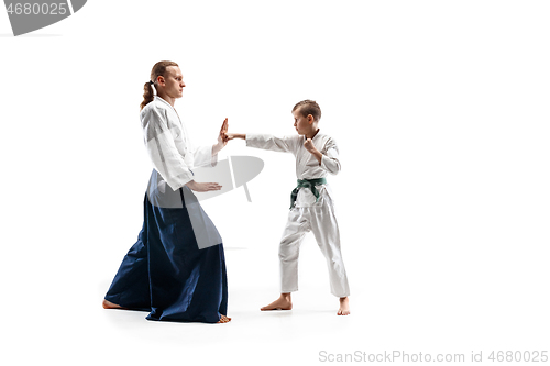 Image of Man and teen boy fighting at aikido training in martial arts school