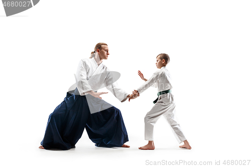 Image of Man and teen boy fighting at aikido training in martial arts school