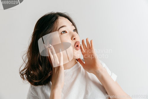 Image of Isolated on pink young casual woman shouting at studio