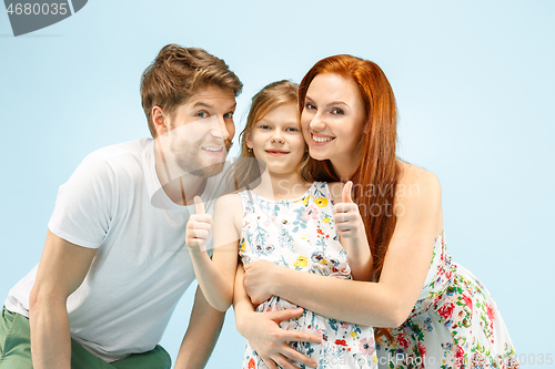 Image of Happy parent with daughter at studio isolated on blue background