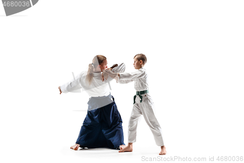 Image of Man and teen boy fighting at aikido training in martial arts school