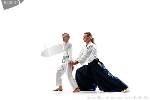 Image of Man and teen boy fighting at aikido training in martial arts school