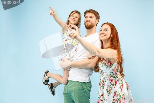 Image of Happy parent with daughter at studio isolated on blue background