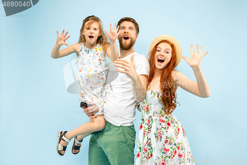 Image of Happy parent with daughter at studio isolated on blue background