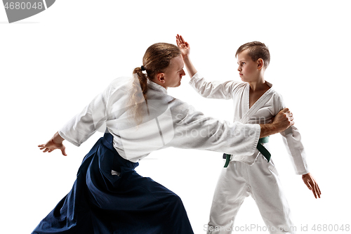 Image of Man and teen boy fighting at aikido training in martial arts school