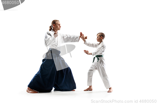 Image of Man and teen boy fighting at aikido training in martial arts school