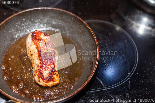 Image of Finished veal steak in a pan