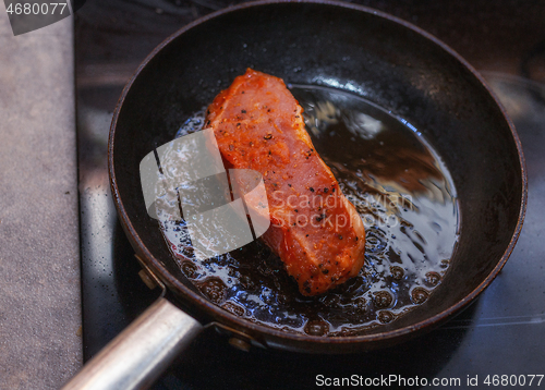 Image of Raw veal steak in a pan