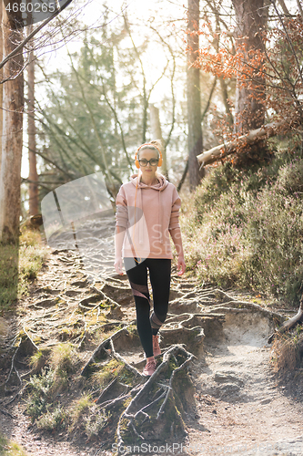 Image of Young fit woman hiking in nature. Adventure, sport and exercise.