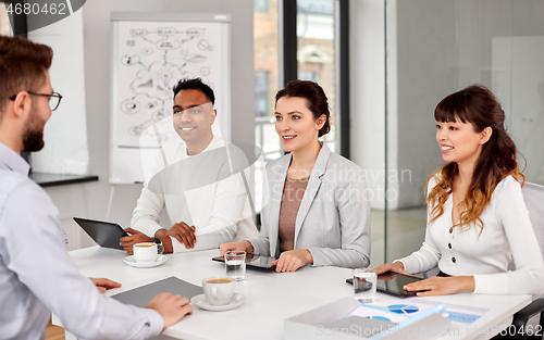 Image of recruiters having job interview with male employee