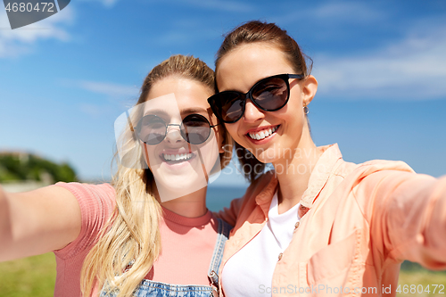 Image of teenage girls or friends taking selfie in summer