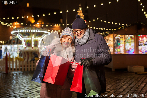 Image of old couple at christmas market with shopping bags