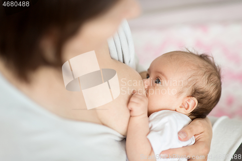 Image of close up of mother breastfeeding newborn baby