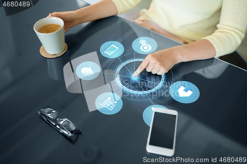 Image of woman with app icons on interactive panel