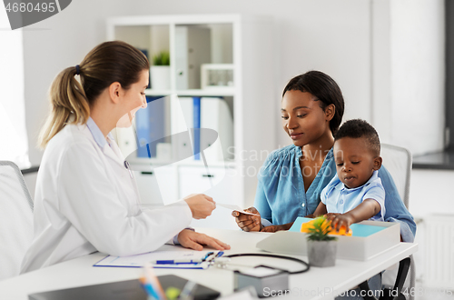 Image of happy mother with baby son and doctor at clinic