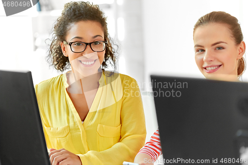 Image of happy high school students in computer class