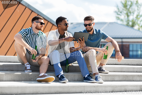 Image of men with tablet pc drinking beer on street