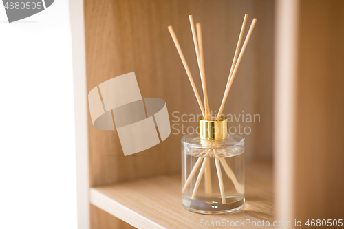 Image of aroma reed diffuser on wooden shelf