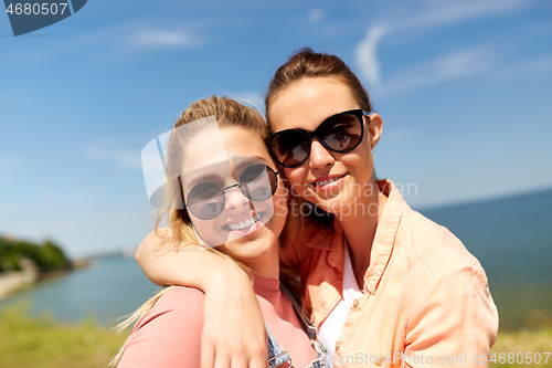 Image of teenage girls or best friends at seaside in summer