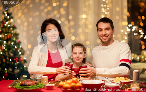 Image of happy family having christmas dinner at home