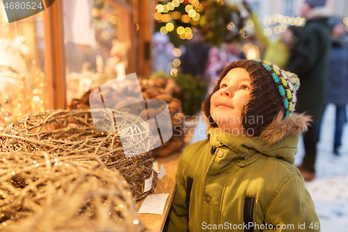 Image of happy little boy at christmas market in winter