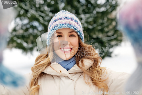 Image of smiling woman taking selfie outdoors in winter