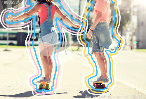 Image of teenage couple riding skateboards on city street