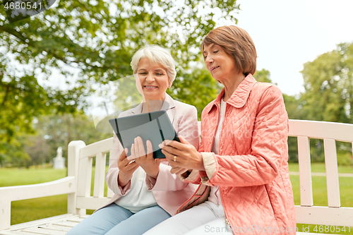 Image of senior women with tablet pc at summer park