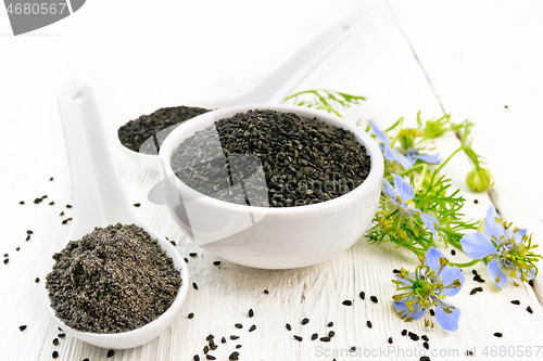 Image of Seeds of black cumin in bowl on board