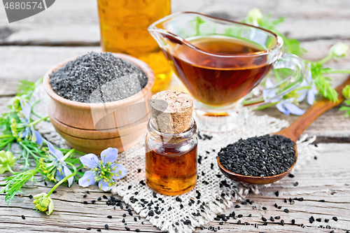 Image of Oil kalingi in bottles and gravy boat on old wooden board