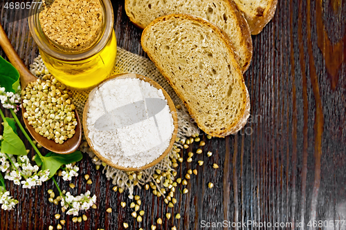 Image of Flour buckwheat green in bowl with bread on dark board top