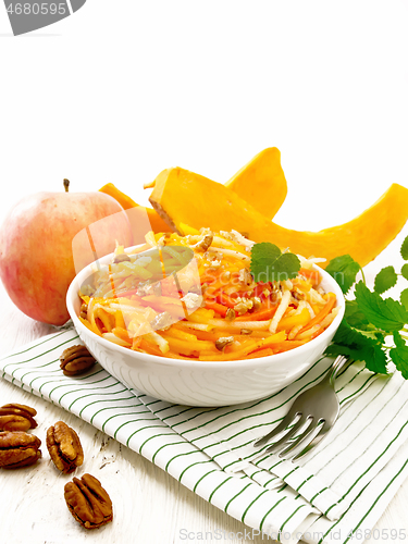 Image of Salad of pumpkin and apple in bowl on white board