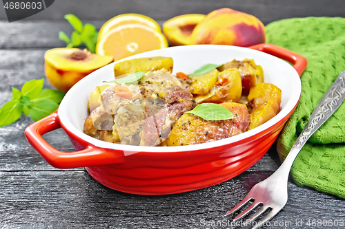 Image of Turkey with peaches in pan on board