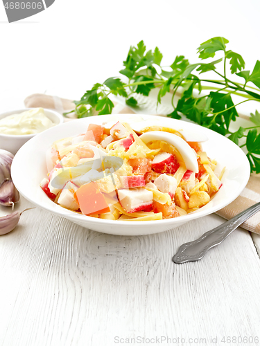 Image of Salad of surimi and tomatoes with eggs on board