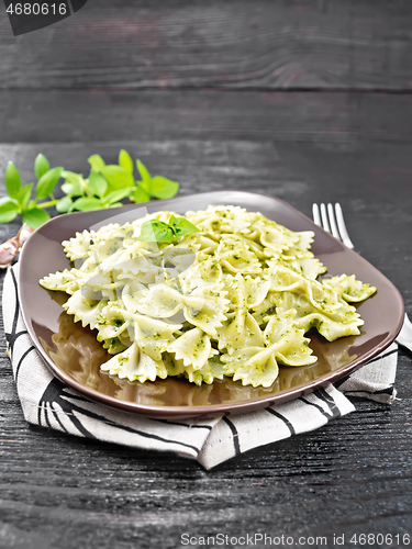 Image of Farfalle with pesto in plate on table