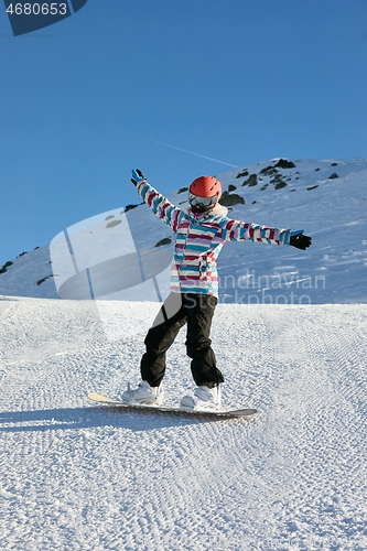 Image of Female snowboarder in the Alps