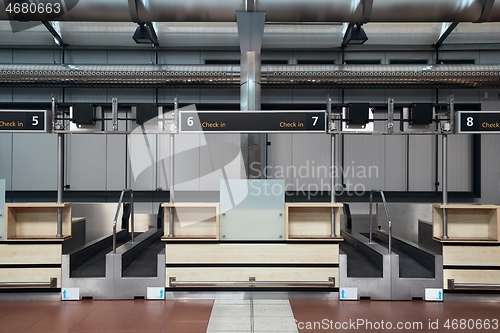 Image of Check-in counters and baggage conveyors at an airport