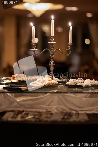 Image of Candles and cookies in an elegant saloon