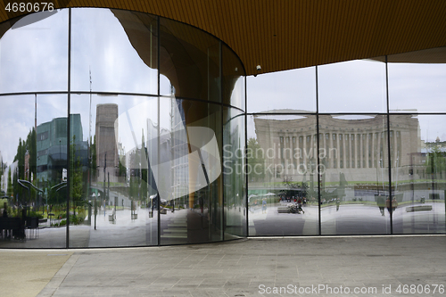 Image of the glass façade of the Central library in Helsinki reflects th