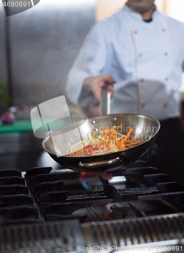 Image of Chef doing flambe on food