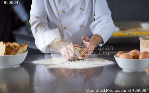 Image of chef hands preparing dough for pizza