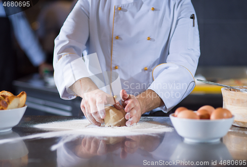 Image of chef hands preparing dough for pizza