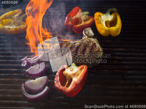 Image of steak with vegetables on a barbecue