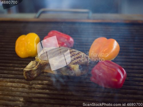 Image of steak with vegetables on a barbecue