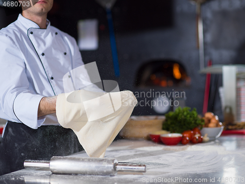 Image of chef throwing up pizza dough